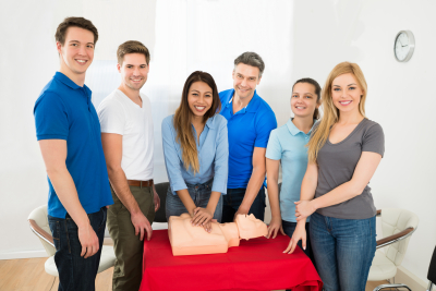 group of multiethnic people learning how to perform cpr